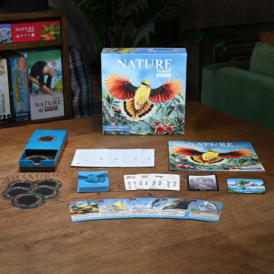 Nature-themed board game components on a wooden table