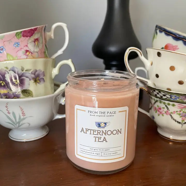Jar of 'Afternoon Tea' candle with vintage teacups in the background