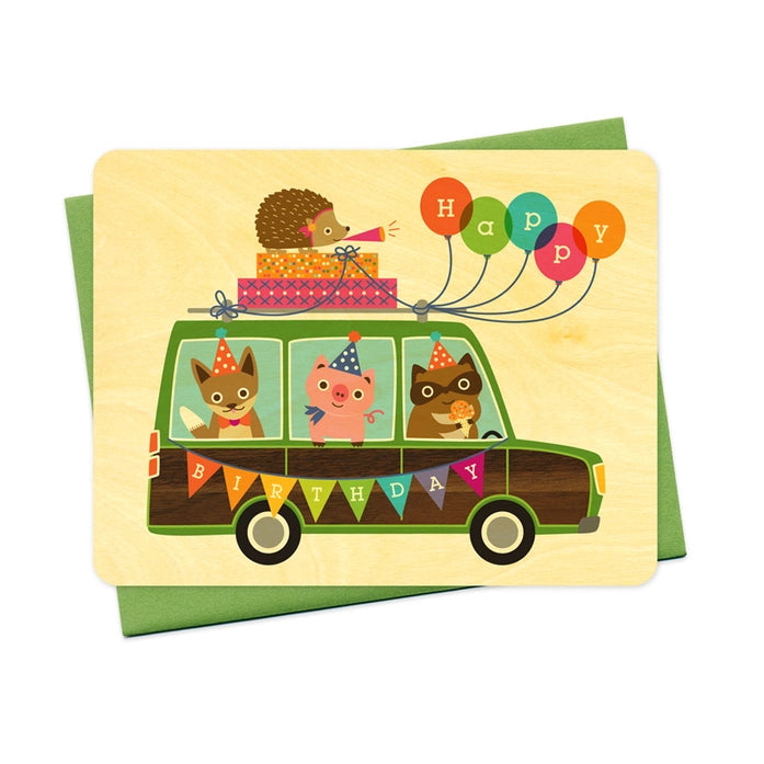 Handcrafted wooden birthday card with colorful art showing animals traveling in a station wagon with balloons