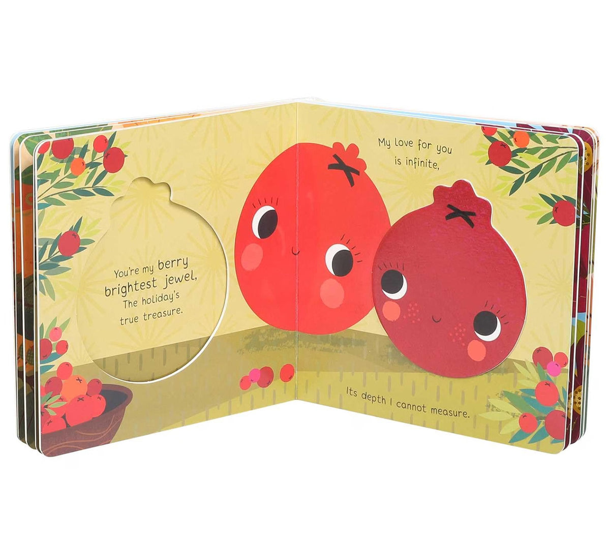 An open children's board book with a hole-punch on the left page, showing two smiling red pomegranate characters on a yellow background with floral borders and printed text.