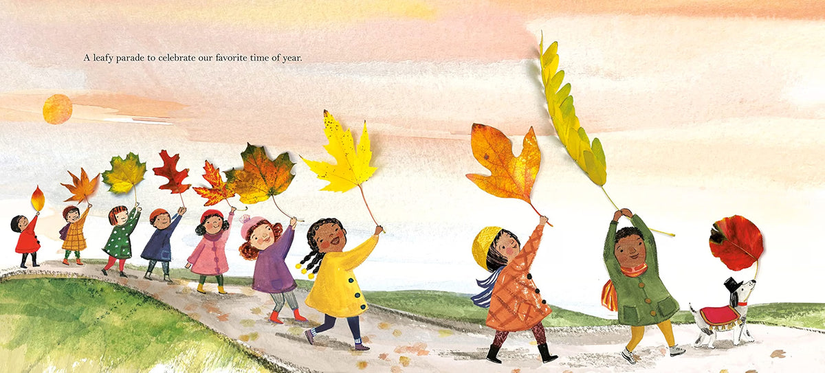 A children's book illustration showing a line of children walking along a path and waving large autumn leaves, with a small dog beside one child. The scene has a warm pastel sky and grassy hills, with the text 'A leafy parade to celebrate our favorite of year.