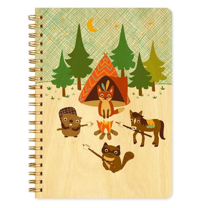 Notebook with animal illustrations in a forest setting